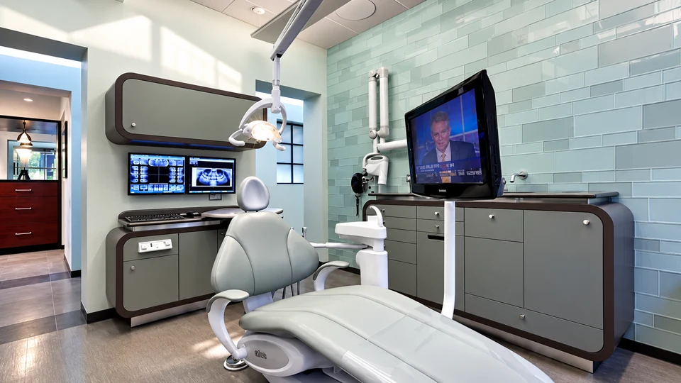 Modern dental treatment room with digital displays