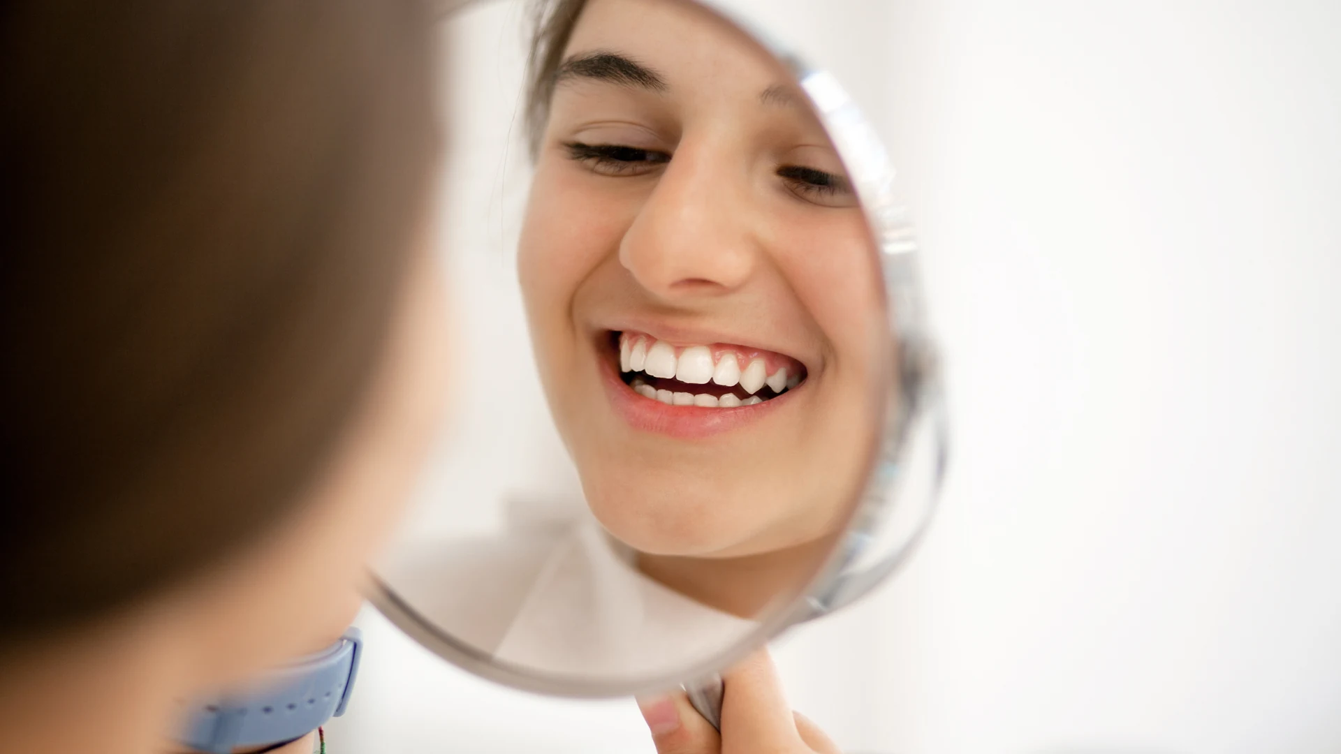 Patient smiling at her reflection